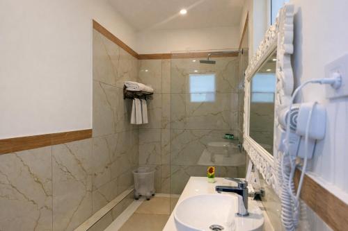 a bathroom with a sink and a shower at Yog Niketan Villa in Rishīkesh