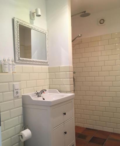 a white bathroom with a sink and a mirror at Wanderer und Radlerzimmer in Lieser