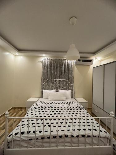 a bedroom with a bed with a black and white mattress at Giza - faisal in Cairo