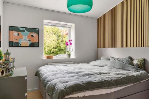 a bedroom with a large bed and a window at Mårslet - close to ocean and city in Mårslet