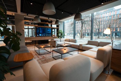 a living room with couches and a flat screen tv at Q Hotel Plus Wrocław in Wrocław