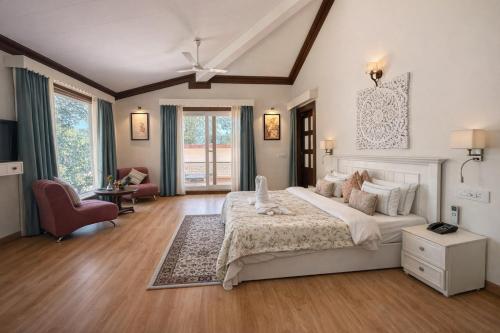 a bedroom with a large white bed in a room at Yog Niketan Villa in Rishīkesh
