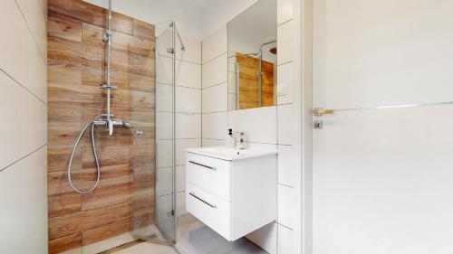 a bathroom with a white sink and a shower at Studio Fibra Choco in Rybnik