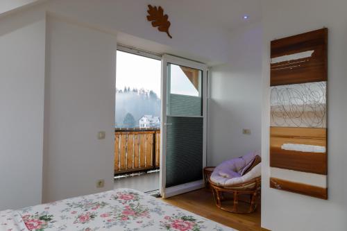 a bedroom with a large window with a view at Vila Rajska ptica in Bled