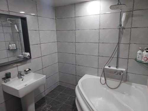 a bathroom with a toilet and a sink at Hotelharu in Eumseong