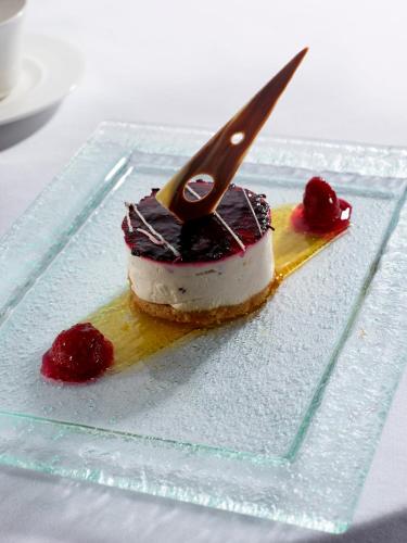 a piece of cake on a glass plate with a knife at Warwick Conferences - Radcliffe in Coventry