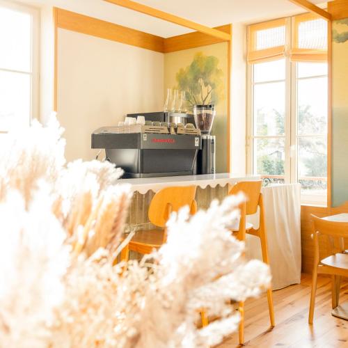 a kitchen with a grill and chairs and windows at Hotel Saint Julien in Biarritz