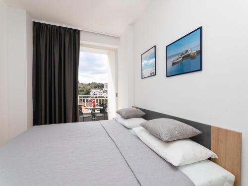 a hotel room with a bed and a balcony at Villa Supe in Supetar