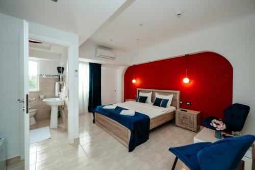 a bedroom with a large bed and a red wall at Vila Diamond in Saturn