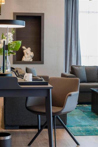 a living room with a table and a couch at Wish More Hotel Istanbul in Istanbul