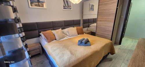 a bedroom with a bed with a blue towel on it at Apartament SORENTO 7 in Gorzów Wielkopolski