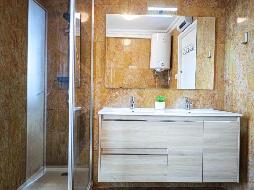a bathroom with a sink and a shower at LITORAL COSTA DORADA - CORAL Only families in Cambrils