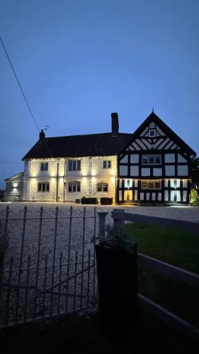 a large white building with lights on it at night at Spenford House 1640 listed house Idilic Location pub walking distance in Shrewsbury