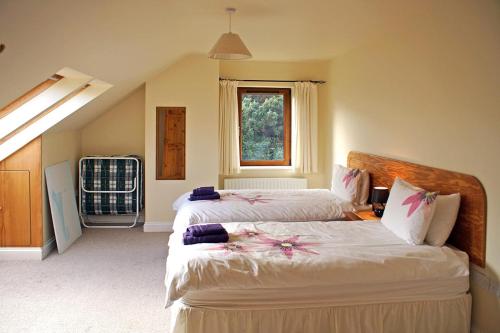 a bedroom with two beds and a window at 4 Bed in Inch oc-i183 in Anascaul