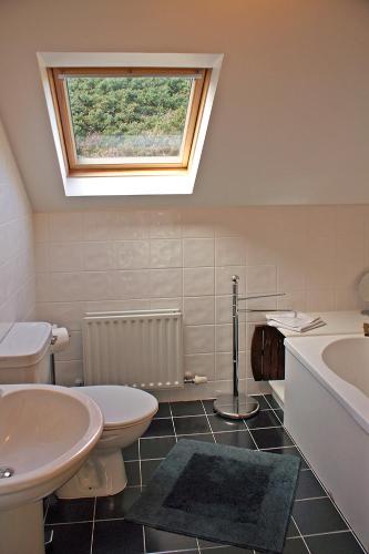 a bathroom with two toilets and a sink and a window at 4 Bed in Inch oc-i183 in Anascaul