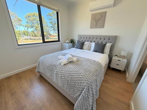 a bedroom with a large bed and a window at Monash Ensuite room with shared kitchen & laundry in Oakleigh East