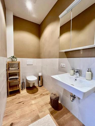 a bathroom with a sink and a toilet at Ferienwohnung in Cammer