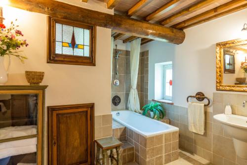 a bathroom with a tub and a sink at Antica Filanda Sunshine in Arezzo