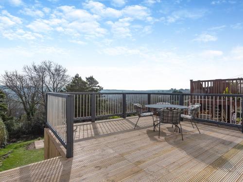 a wooden deck with a table and chairs on it at The Laurels in Goodwick