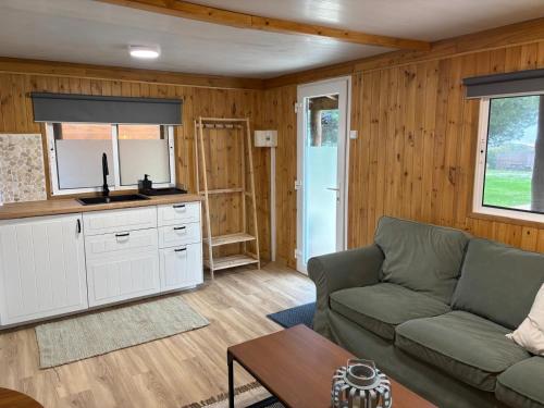 a living room with a couch and a table at Country Spot - Summer House in Porto Covo