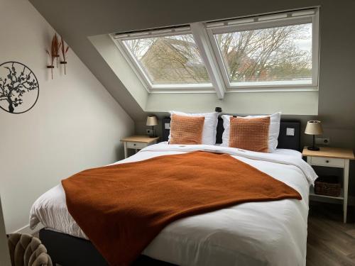 a bedroom with a large bed with a window at Rue Haute by M&M 4 sterren bed en breakfast vlakbij Maastricht in Eben-Emael