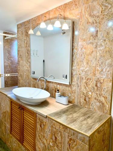 a bathroom with a sink and a mirror at Èlmèny Vendègház in Csurgó