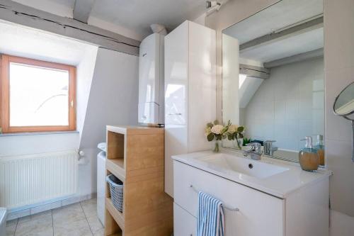 a white bathroom with a sink and a window at Le Nid Alsacien - Centre Ville - Proche Parking Gratuit - Europa-park in Erstein