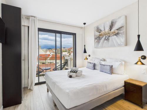 a bedroom with a bed and a large window at Residence Provencal - Luxurious - 300m Palais - LRA CANNES in Cannes
