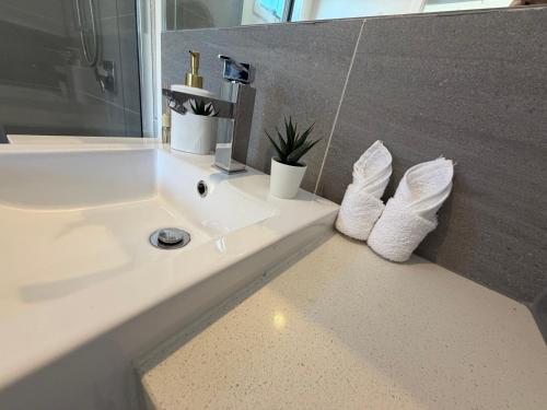 a bathroom with a sink with white socks on it at Monash Ensuite room with shared kitchen & laundry in Oakleigh East