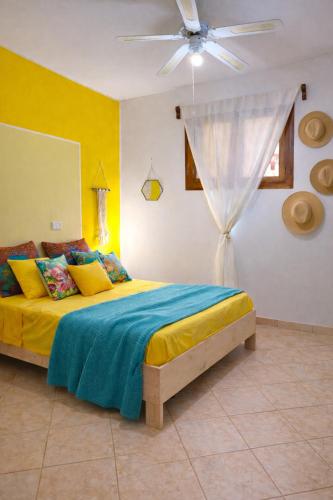 a bedroom with a bed and a ceiling fan at Casa Carlotta - 100m from the Beach, Maio in Vila do Porto