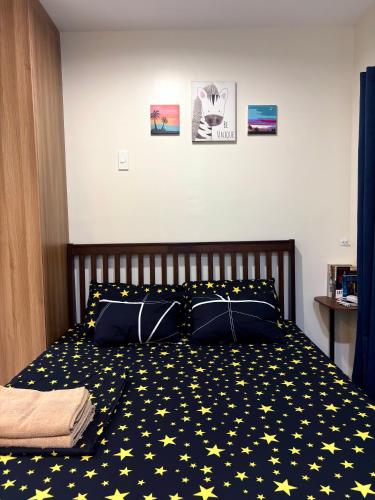 a bedroom with a bed with stars on it at The Midpoint Residences - Studio Unit in Cebu City