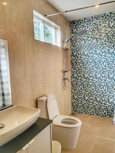 a bathroom with a toilet and a shower at Kirati Beach Resort in Choeng Mon Beach