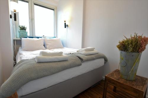a bedroom with a bed with towels on it at Quantic Apartment in Warsaw