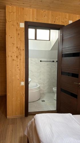 a bedroom with a bathroom with a shower and a toilet at Kashmiri kitchens hotel in Gudauri