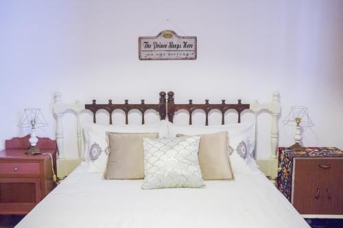 a bedroom with a large white bed with pillows at Aminta Home in Las Palmas de Gran Canaria
