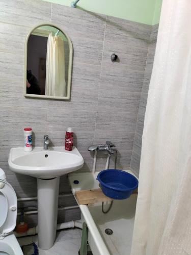 a bathroom with a sink and a toilet and a mirror at жилой дом МОСКВА in Aktobe