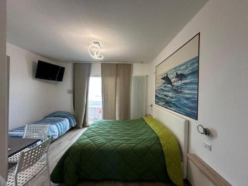 a bedroom with two beds and a table and a television at Chalet del Sol in Fano