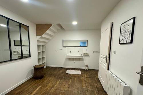 a bathroom with a sink in the middle of a room at Le Lido Maison 6 personnes in Saint-Varent