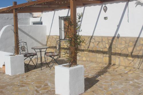 a patio with a table and chairs in a tent at Casa Ruby in Huércal-Overa