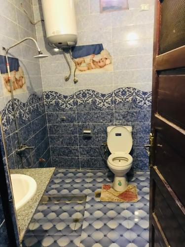 a bathroom with a toilet and a sink at Nubian house in Jazīrat Salūjah