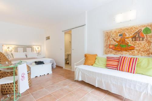 a living room with two beds and a table at Garden view in Cascais