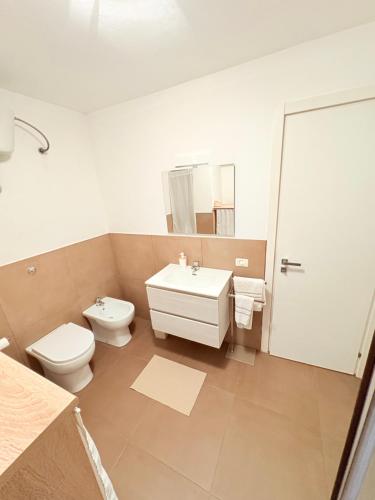 a white bathroom with a toilet and a sink at M&S Home in Agrigento