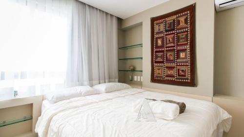 a bedroom with a large white bed with a plaque on it at Flat in Boa Viagem leisure great location PM805 in Recife