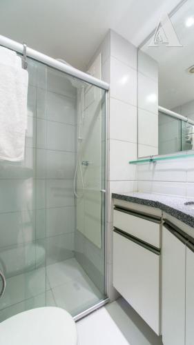 a bathroom with a glass shower and a toilet at Flat in Boa Viagem leisure great location PM805 in Recife