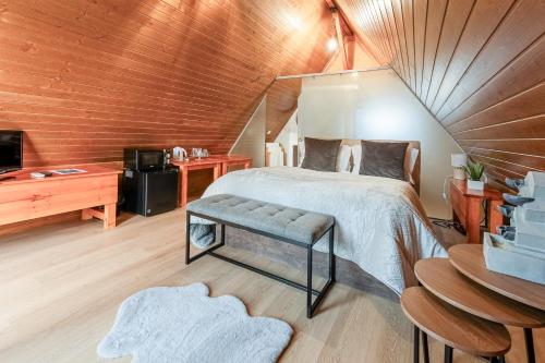 a bedroom with a bed and a tv in a room at Lena Village - Hotel and Spa in Mortágua