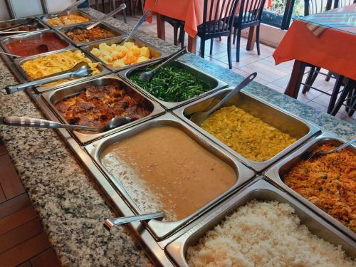 a buffet line with many different types of food at Casa de Pedra Mineira in Canela