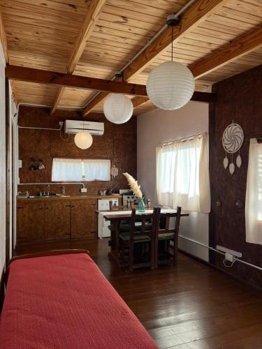 a living room with a table and a kitchen at Cabaña Viedma in Viedma