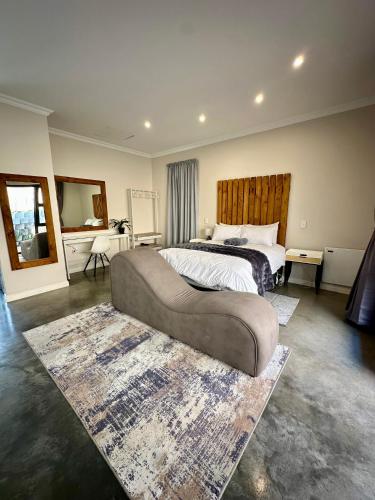 a bedroom with a large bed and a large rug at Fern Rivers Self-Catering Accommodation in Pietermaritzburg