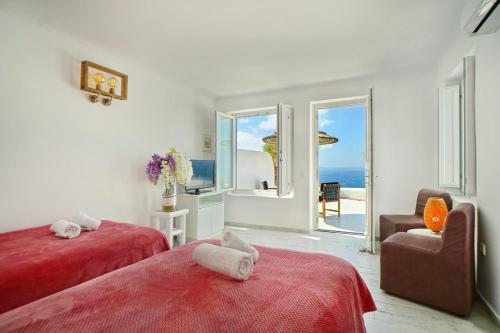a bedroom with two beds and a view of the ocean at Zinas Villas in Fanari