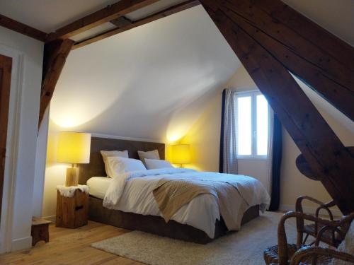 a bedroom with a large bed in an attic at La chambre du Villard in Saint-Béron
